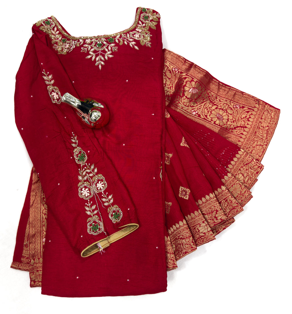 Red embroidered traditional outfit with gold details on a white background